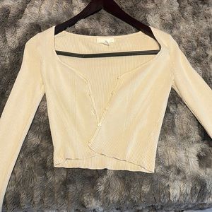 Cream color, long sleeve crop top, button up.